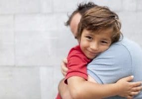 little boy hugging his dad
